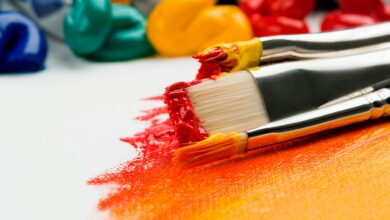 Close up of paint and paint brushes on white canvas